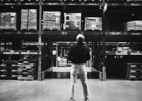 A person is watching stock inventory in the warehouse