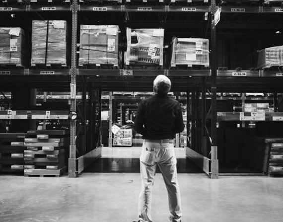 A person is watching stock inventory in the warehouse
