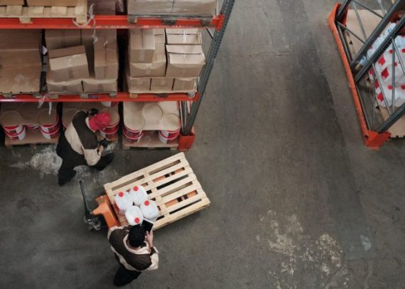 two persons managing inventory in warehouse